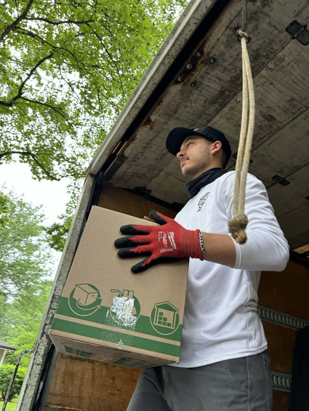 Professional mover carefully handling boxes with expert care