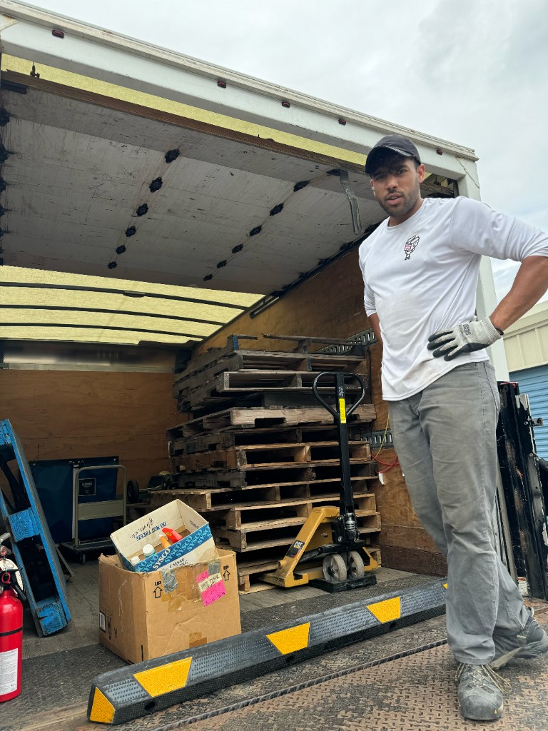 Little Fellas Moving crew member with a pallet jack during a commercial job