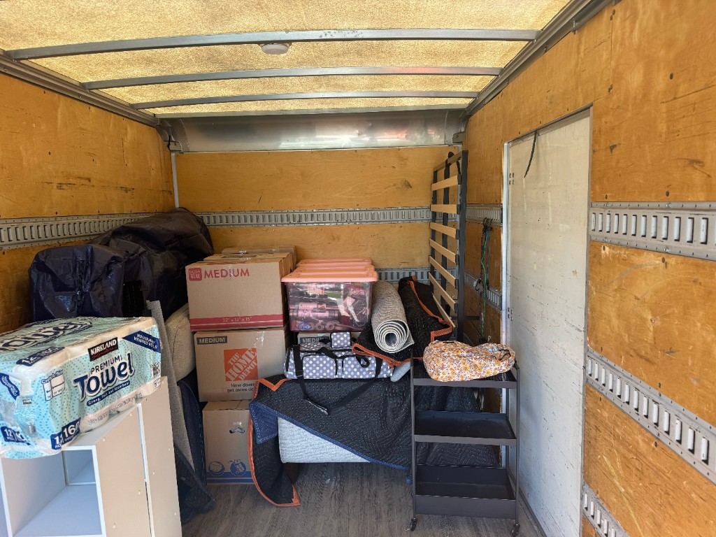 Loaded moving truck with stacked customer boxes and packed inventory